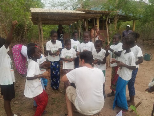 Fede, Director of JGIS playing the drums for the Roots and Shoots kids